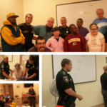 A group of people emphasizing internet safety by posing in front of a white board.