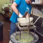 A man in a blue shirt engaged in supported employment.