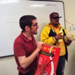 A man holding a coca cola box.