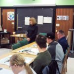 A group of people in a classroom.