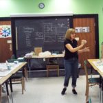 A lady teaching students in the class