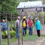 A group of people standing in a garden.