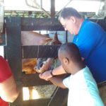 A group of people petting a horse.