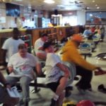 A group of people in a bowling alley.