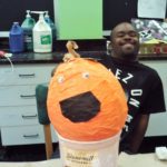 A man holding a pumpkin.