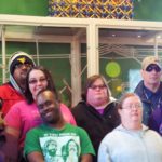 A group of people posing for a picture in a store.