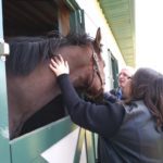 A girl showing love to a horse