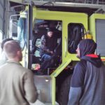 A group of men standing in front of a fire truck.